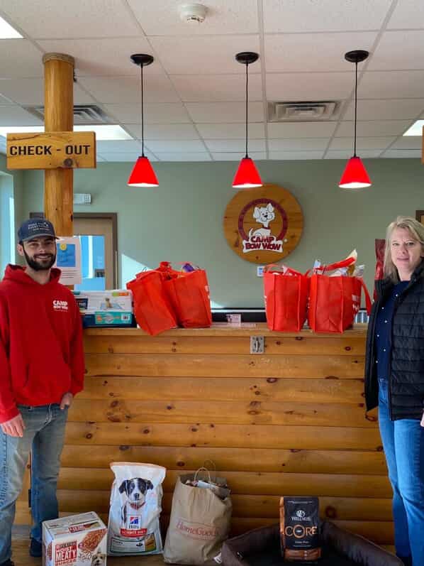Camp Bow Wow team with donations for shelter